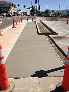 Concrete sidewalk with horizontal strain-relief grooves 2014-06-12 10 38 10 Fresh sidewalk along U.S. Route 95 (West Winnemucca Boulevard) near Melarkey Street and Nevada State Route 289 (Winnemucca Boulevard) in Winnemucca, Nevada.JPG