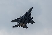 An F-15E Strike Eagle, tail number 91-0302, taking off from RAF Lakenheath in England. The aircraft is assigned to the 492nd Fighter Squadron.