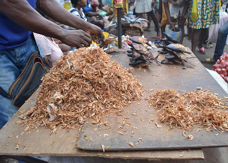 File:A man selling dried crayfish in african market.jpg