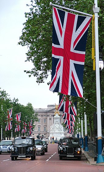 Union Flag being flown on The Mall, London looking towards Buckingham Palace