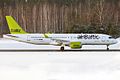 left side, snow, trees behind, airBaltic