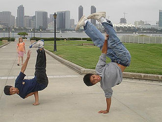 The bboy on the left stabs with his right arm to facilitate his airchair. Airchairpike.jpg