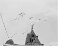 Airplanes passing over the county court house in Bolivar, Missouri, during ceremonies marking the presence in Bolivar... - NARA - 199901.jpg