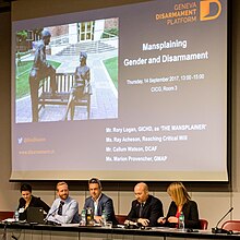 Gender and Disarmament Platform meeting, 14 September 2017. On the slide: a photograph of the sculpture Classmates by Paul Tadlock, which has been called the "mansplaining sculpture" and "Mansplaining The Statue" by people on the internet. CSP 2017 day 4 (37249059025) (cropped).jpg