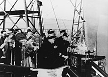 Mrs. James H. Doolittle christens Shangri-La at the Norfolk Navy Yard, Virginia, 24 February 1944