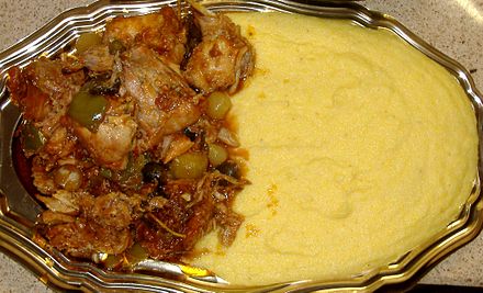 A typical plate of polenta (here depicted with rabbit), a very common and traditional dish of the region