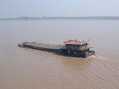 Self-propelled barge carrying bulk crushed stone