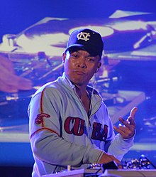 DJ Qbert manipulating a record turntable at a turntablism competition in France in 2006 DJ Q-bert in France (cropped).jpg