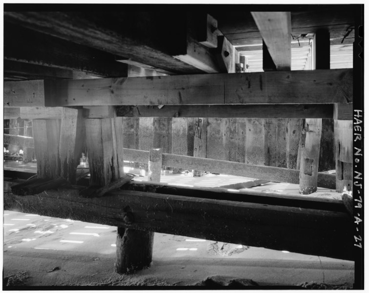 File:Detail of wharf A timber framing, showing piers and pier caps or plates stepping down for a sloped launching deck, now built-up for a flat deck, interior of sheet steel bulkhead HAER NJ,13-HIGH,1A-27.tif