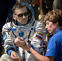 Yuri Malenchenko has been to the ISS five times, which is more than anyone else. He is shown here in 2016, after returning to Earth from Expedition 47. Expedition 47 Soyuz TMA-19M Landing (NHQ201606180034).jpg