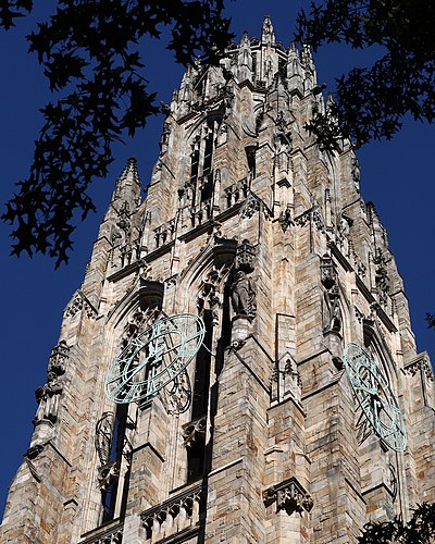 The bronze clock on Harkness Tower at Yale University, a structure reflecting the Collegiate Gothic architectural genre