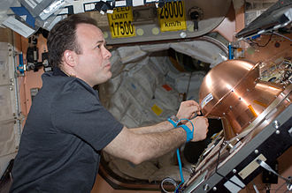 Ron Garan, ISS Expedition 28 flight engineer, prepares the Reentry Breakup Recorder (REBR) for installation in the Automated Transfer Vehicle-2 (ATV-2) in 2011. ISS-28 Ron Garan prepares the Reentry Breakup Recorder.jpg