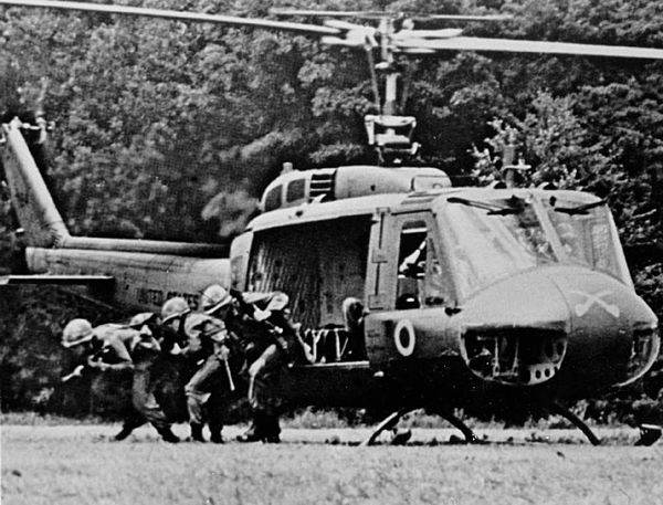 A rifle squad from the 1st Squadron, 9th Cavalry exiting from a UH-1D