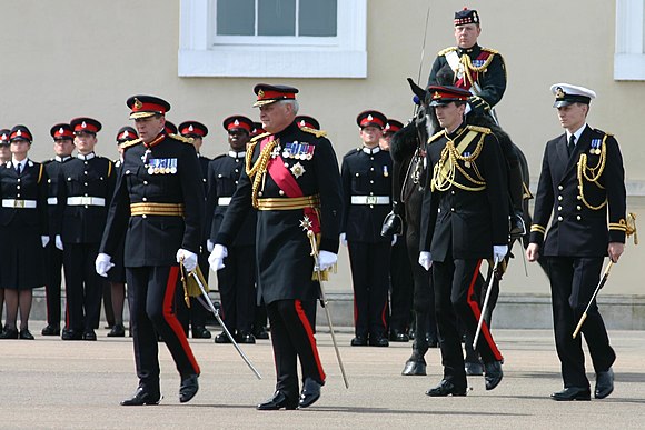 Officer Cadet Wales (standing next to the horse) on parade at Sandhurst, 21 June 2005