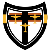 Emblema de uma unidade de combate alemã com a silhueta de três aviões amarelos em uma cruz preta e um fundo branco.