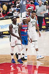Holiday (center) with his brother Jrue (left) of the Milwaukee Bucks in 2021 Jrue and Aaron Holiday with Giannis.jpg
