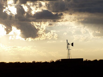 Sunset in the Great Karoo, near Sutherland, showing a multibladed windpump, which has made permanent settlement and farming possible in this thirsty land. These windpumps are as iconic of the Great Karoo as are the flat-topped Karoo Koppies.