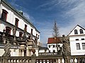 Terasa se sochařskou výzdobou před kostelem sv. Vojtěcha a klášterní gymnázium