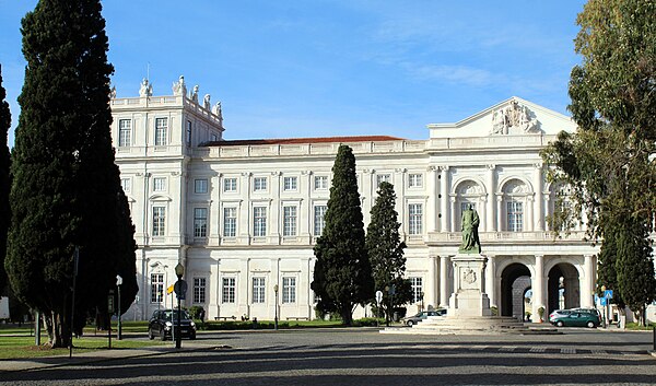 A monument to King Carlos I in front of the main façade of Ajuda Palace.