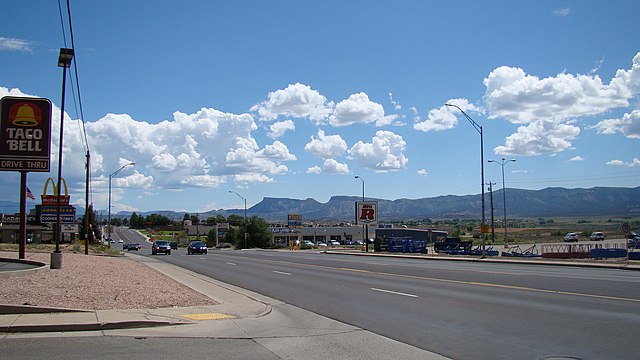 View looking SE of Main Street in Cortez, with the cliff faces of the Mesa Verde visible in the distance.