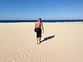 "Man_in_the_dunes_looking_at_sea_in_Fuerteventura.jpg" by User:Pittigrilli