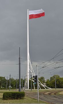 The largest Polish flag flying from the Freedom Mast in Warsaw, which, at 63 metres (207 ft), is Poland's tallest flag pole Masz Wolnosci w Warszawie 2015.JPG