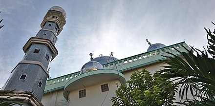 One of Medan's numerous mosques, with tiled minaret and domes visible.