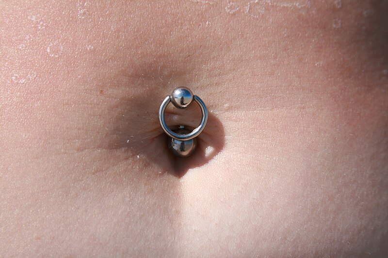belly button piercing with a curved barbell