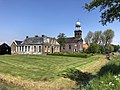 Netherlands, Oosterzee, house at Buren 27 and Martinus church.jpg