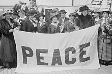 Delegates to the April 1915 Women's International Congress for Peace and Freedom aboard the MS Noordam with their blue and white "PEACE" banner Noordam-delegates-1915.jpg