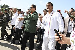 Chavez walking with a cane accompanied by Rafael Correa in Caracas in July 2011, shortly after his first cancer surgery Noveno encuentro presidencial Ecuador - Venezuela (5809138669).jpg