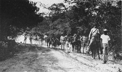 United States Marines with a Haitian guide patrolling the jungle in 1915 during the Battle of Fort Dipitie