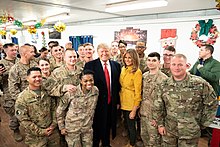 President Donald Trump visits U.S. troops at the Al Asad Airbase in Iraq, 26 December 2018 President Trump the First Lady Visit Troops in Iraq (46502782661).jpg