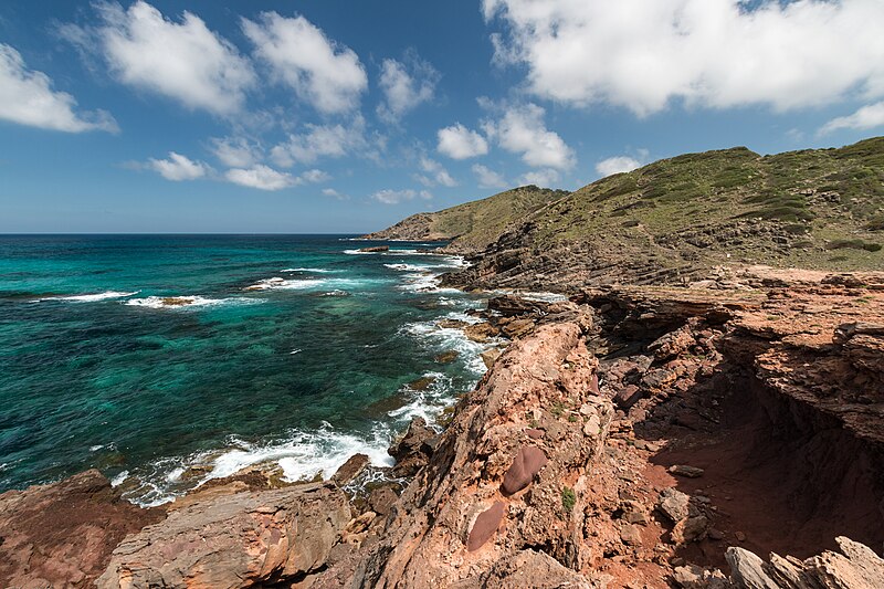 File:Rocks and clouds near Cala del Pilar (16070600597).jpg