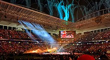 Stage pictured from the audience. Shakira during "Whenever, Wherever" on the screen at the Super Bowl halftime show Super Bowl LIV Halftime Show (49607213091) (cropped).jpg