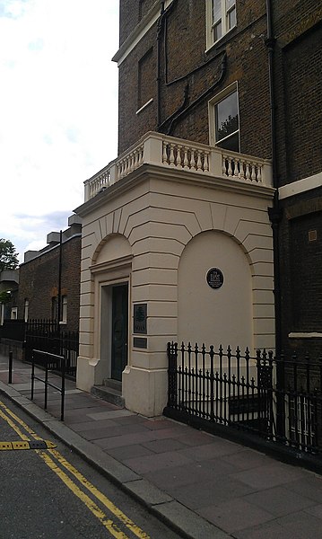 The Faber and Faber building where Eliot worked from 1925 to 1965; the commemorative plaque is under the right-hand arch.