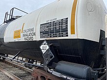 A railway tank car carrying chlorine, displaying hazardous materials information including a diamond-shaped U.S. DOT placard showing a UN number Tank car with placard 1017 (chlorine).jpg