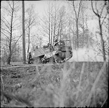 Universal Carrier of the 12th (Queen's Westminsters) Battalion, King's Royal Rifle Corps with Browning machine gun in action against a German MG position, the Netherlands, 2 April 1945. The British Army in North-west Europe 1944-45 BU3154.jpg