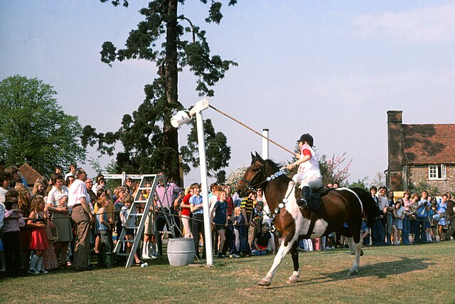 Tilting on horseback at a replica quintain on Offham Green, Kent 1976