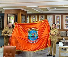 Governor Musaad presents the new flag and emblem in front of Tito Karnavian, the Minister of Home Affair Tito and Governor Papua Barat Daya Emblem.jpg