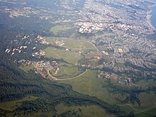UCSC & Santa Cruz aerial view. The Great Meadow is the undeveloped area between city and university UCSC & Santa Cruz Aerial view.jpg