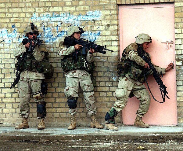 US Army Infantrymen from TF 2–7 CAV prepare to enter a building during fighting in Fallujah.