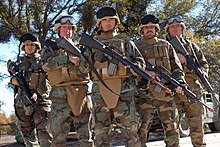 United States Navy sailors in 2007 wearing Lightweight Helmets and Modular Tactical Vests equipped with neck and groin armor US Navy 071211-N-9623R-010 Seabees attached to Naval Mobile Construction Battalion (NMCB) 17's Convoy Security Element (CSE) stand ready to defend. The CSE team is tasked with the safe movement of convoys to and from their miss.jpg