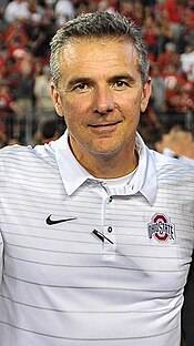 Former head coach Urban Meyer, who led the Buckeyes to seven division titles, three Big Ten Championships, the 2014 national championship, and the team's all-time record winning streak (24) Urban Meyer in 2017 (cropped).jpg