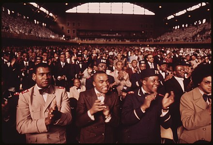 A crowd of Muslims applaud during Elijah Muhammad's annual Saviors' Day message in Chicago in 1974