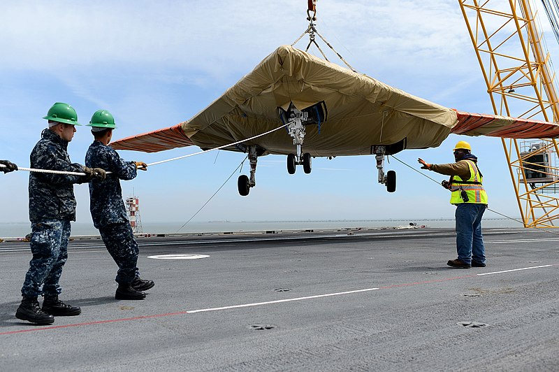 File:An X-47B is loaded onto flight deck aboard USS George H.W. Bush. (8721193532).jpg