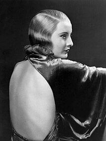 Barbara Stanwyck in the 1933 film Baby Face, wearing a nightgown designed by Orry-Kelly that features a plunging back.