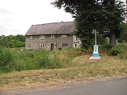 Wayside cross and a house