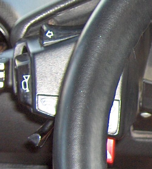 No stalks - control buttons reached by hands on steering wheel