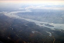 An aerial view of Dnipro. The Dnieper River, city's left and right banks, and a number of bridges can be seen. Dniepropetrowsk z lotu ptaka.jpg